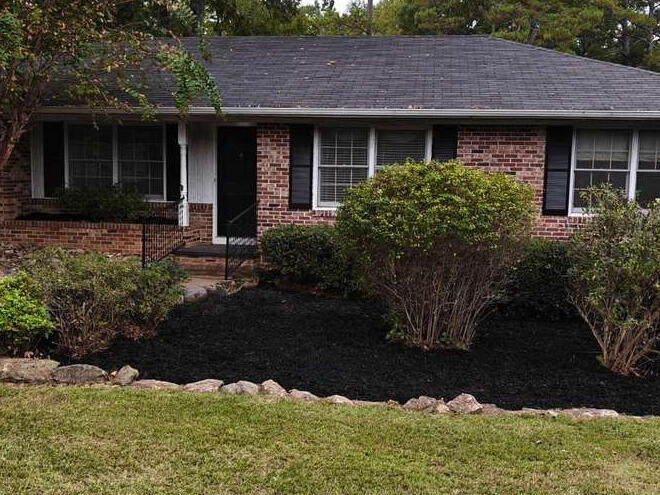 The same Oconee County, GA front yard after shrub trimming, bed cleanup and fresh black mulch