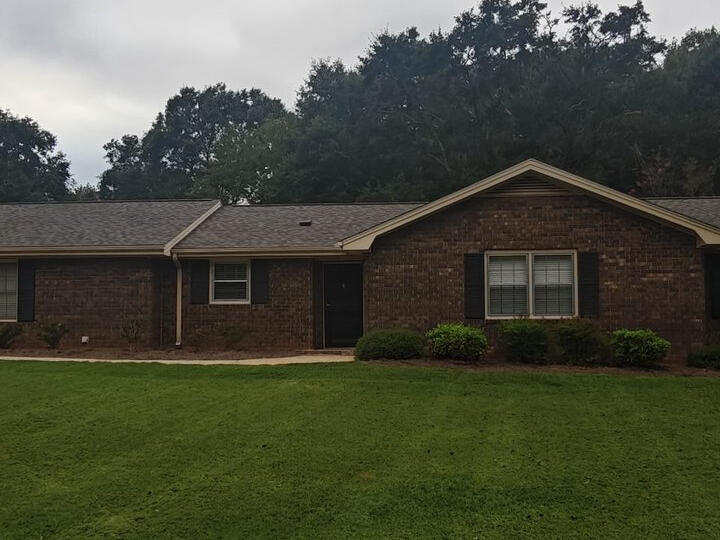 Freshly mowed front lawn at a brick ranch home in Watkinsville, GA